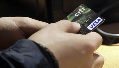
              FILE - In this May 9, 2012 file photo, a Visa credit card is tendered at opening of the Superdry store in New York